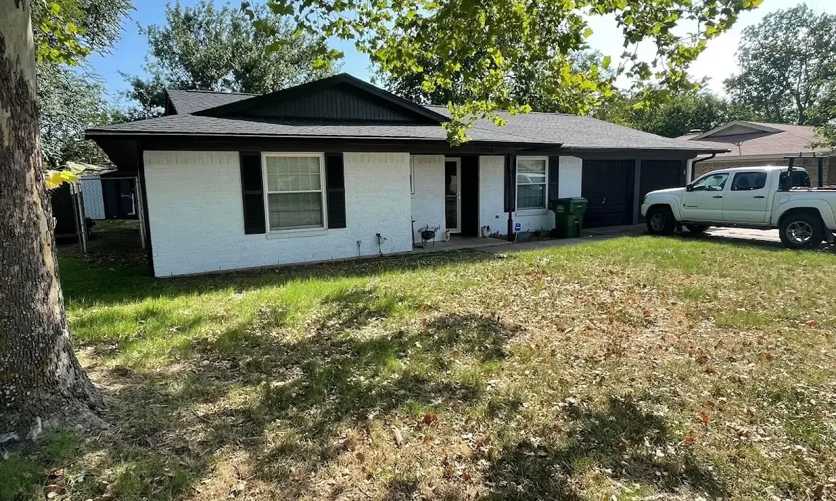 Professional roofing crew working on a residential roof in Argentine